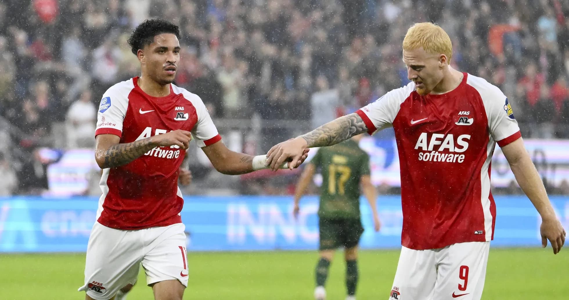 Two AZ Alkmaar players celebrating a goal together Two AZ Alkmaar players celebrating a goal together