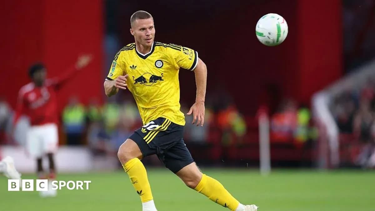 Player in yellow kit chasing a flying ball Player in yellow kit chasing a flying ball