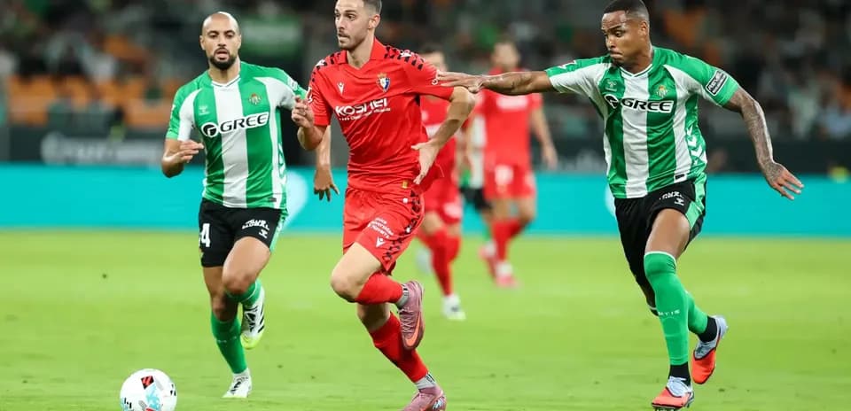 Osasuna player dribbling past Real Betis defenders Osasuna player dribbling past Real Betis defenders