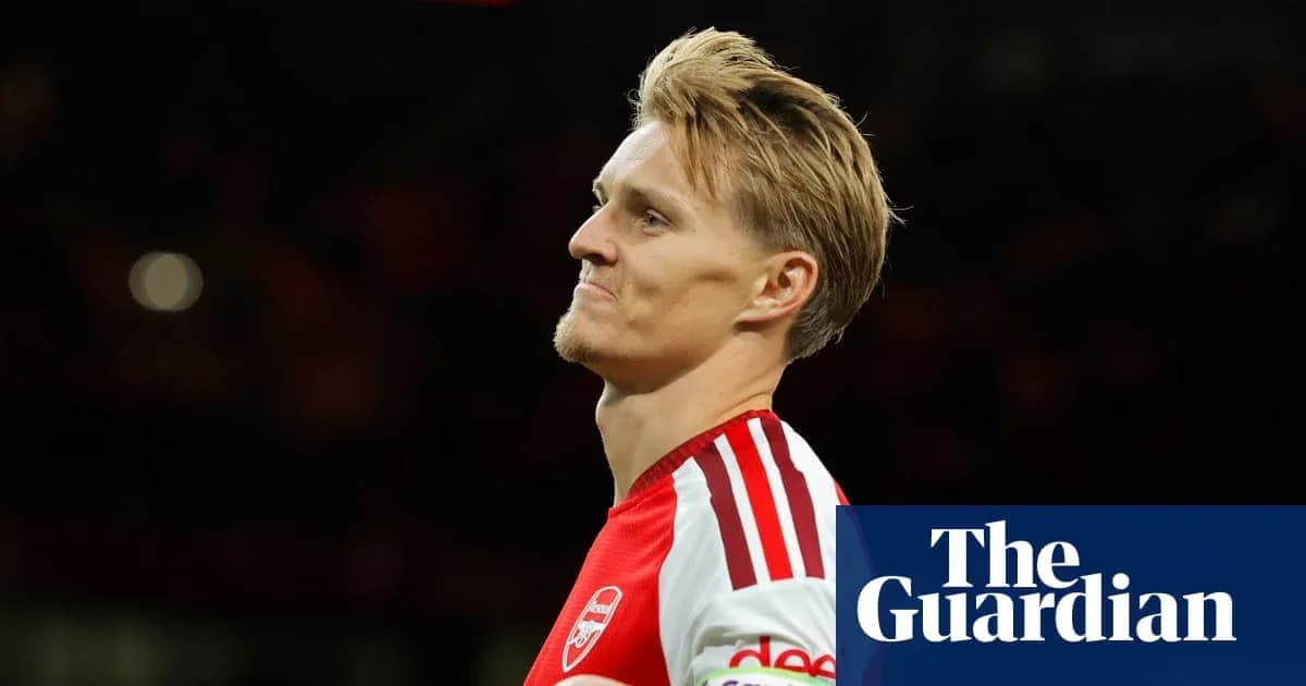 Arsenal player looking contemplative on the pitch Arsenal player looking contemplative on the pitch