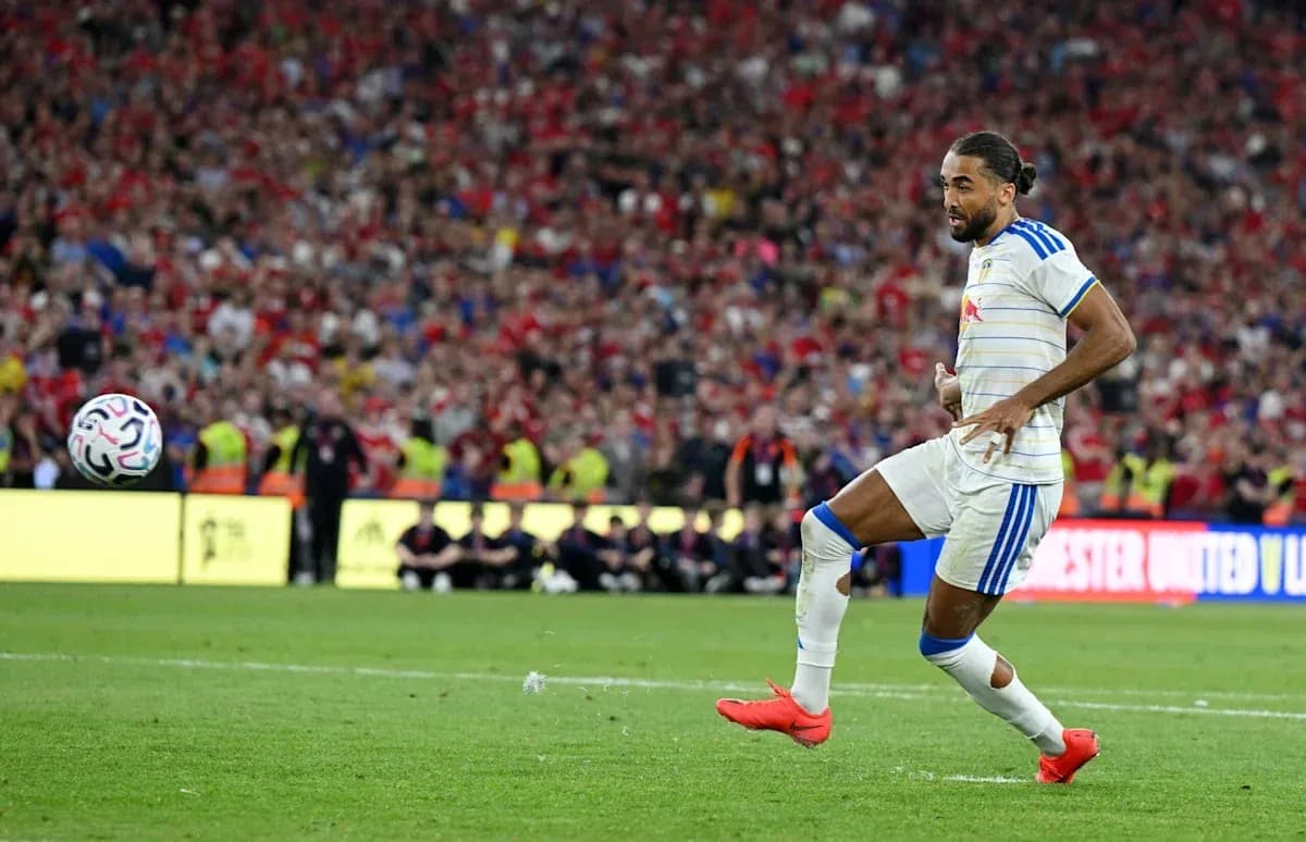 Player kicking ball during a football match Player kicking ball during a football match