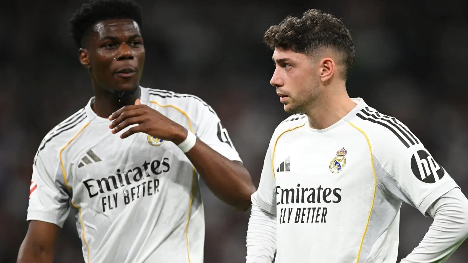 Two Real Madrid players discussing on the field Two Real Madrid players discussing on the field