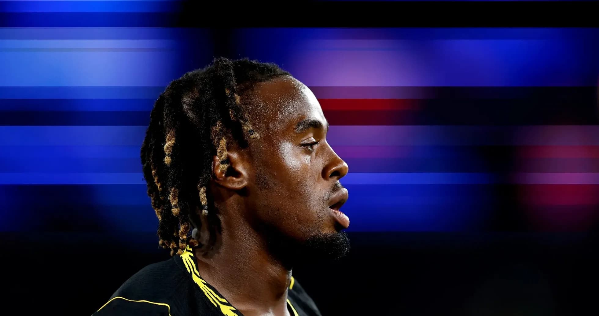 Athlete in profile during sporting event Athlete in profile during sporting event