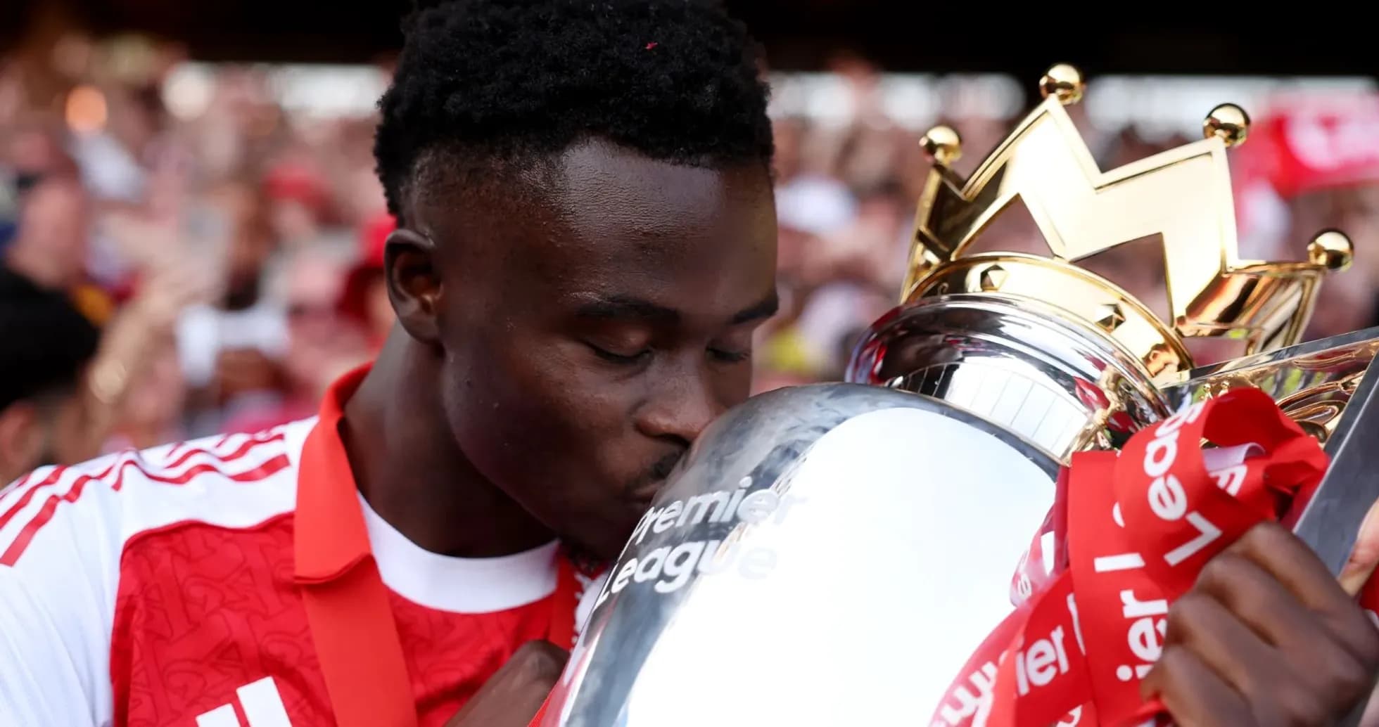 Player kissing Premier League trophy in celebration Player kissing Premier League trophy in celebration