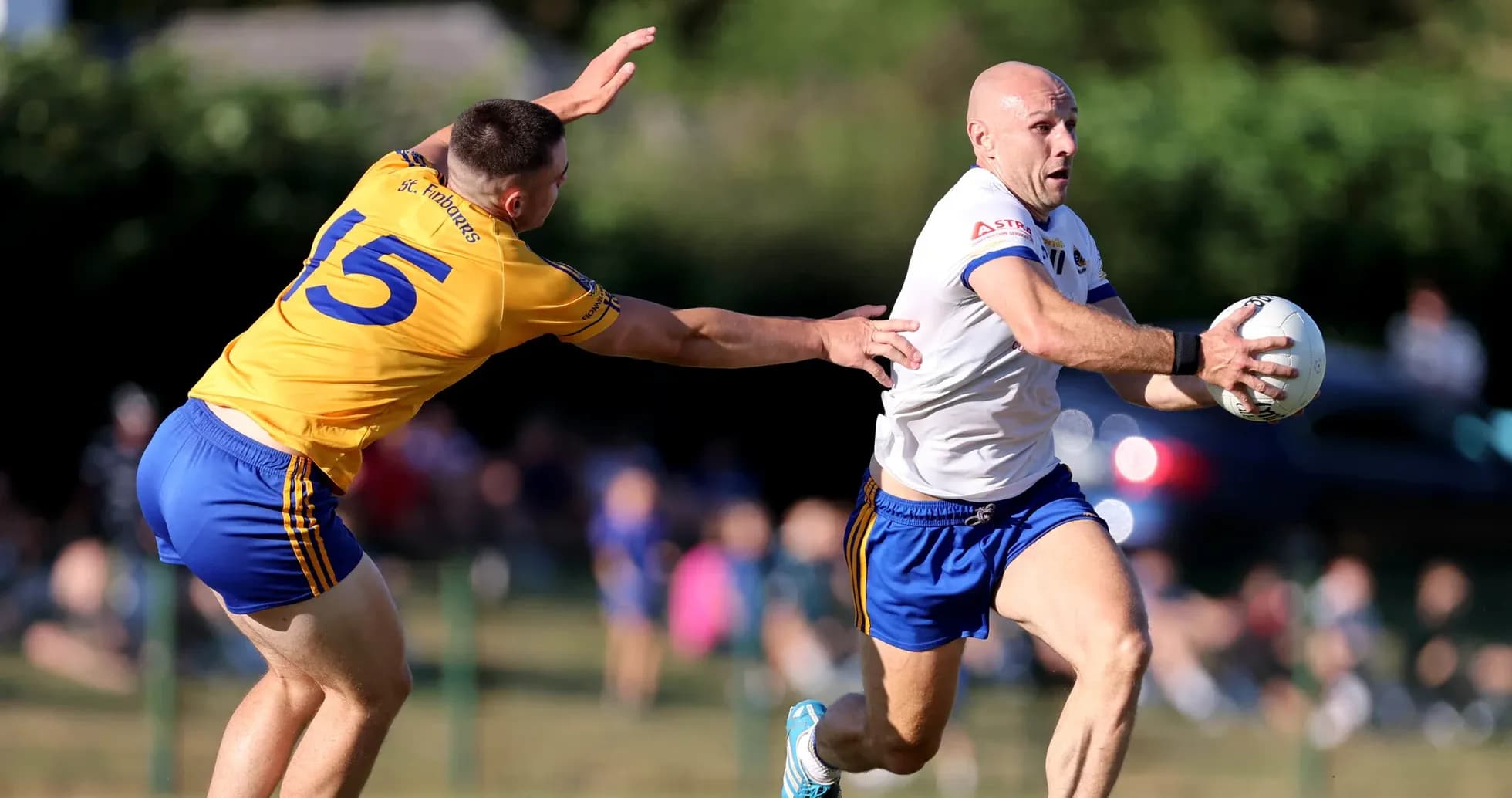 Player running with the ball, defender reaching out Player running with the ball, defender reaching out