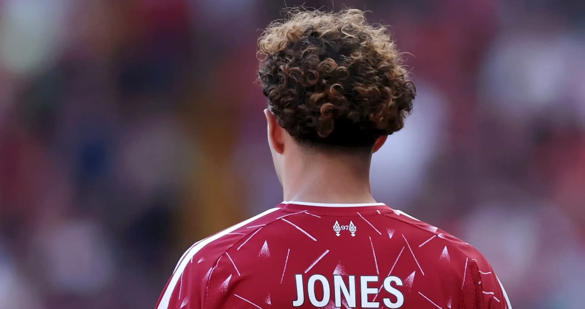 Player in red jersey with 'JONES' on back Player in red jersey with 'JONES' on back