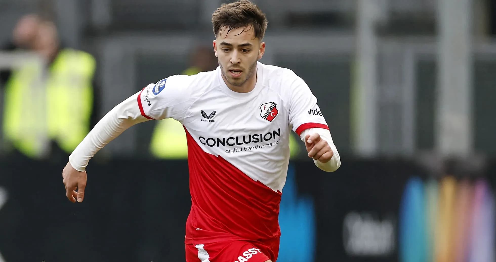 Player in FC Utrecht kit running with the ball Player in FC Utrecht kit running with the ball