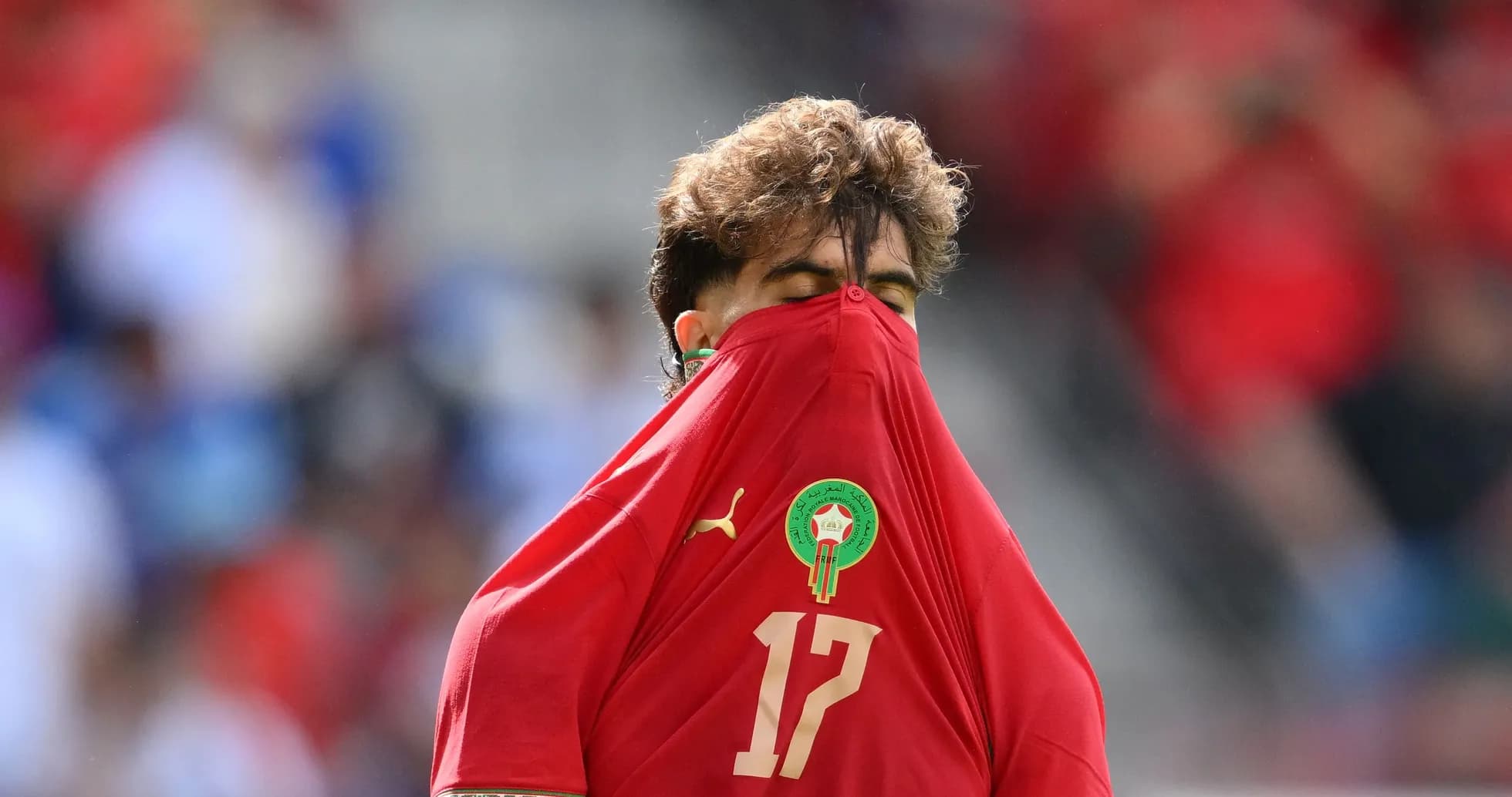 Player covering face with jersey during match Player covering face with jersey during match