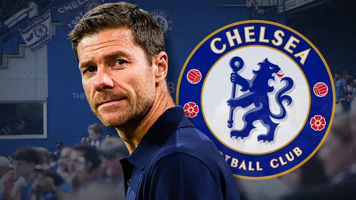 Man standing in front of Chelsea FC logo Man standing in front of Chelsea FC logo