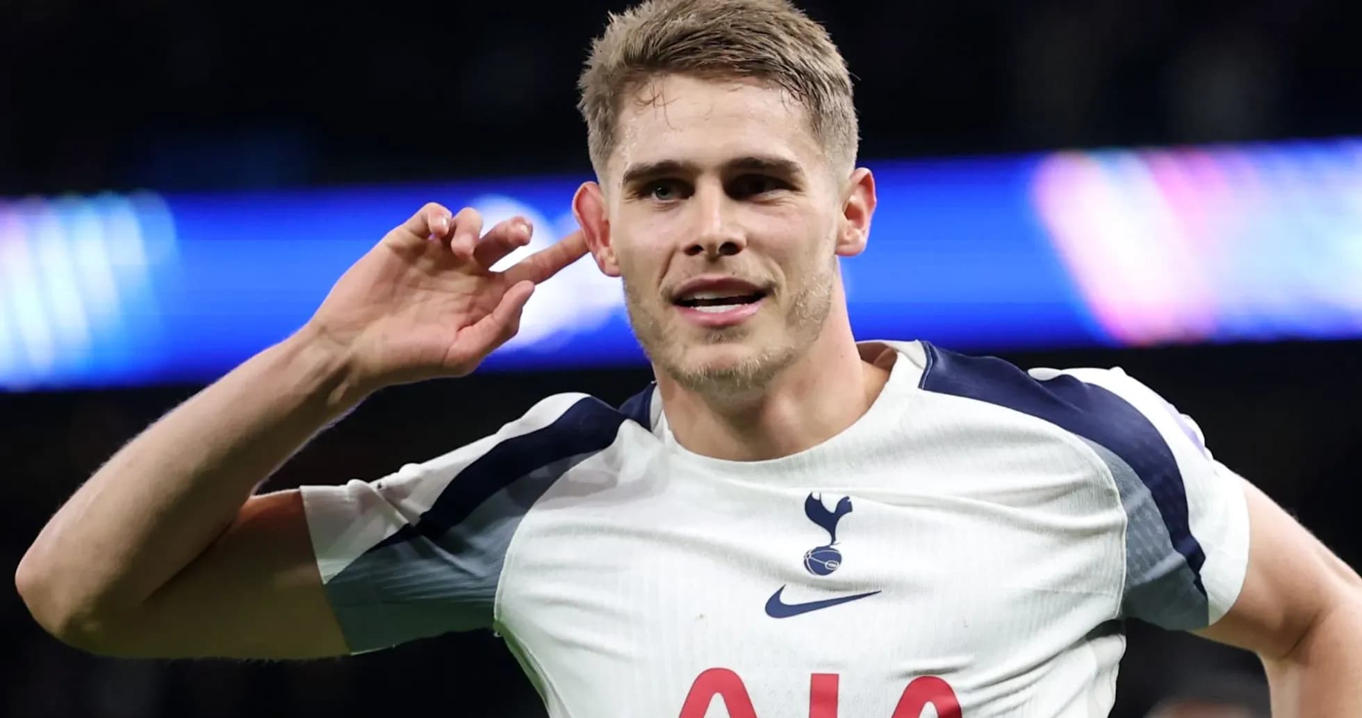 Player celebrating a goal with hand to ear Player celebrating a goal with hand to ear