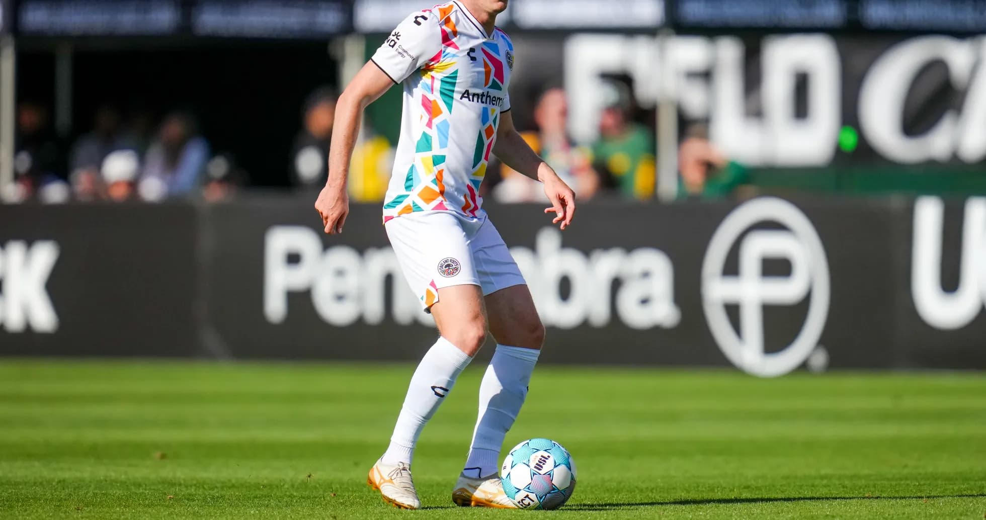 Player dribbling the ball on the field Player dribbling the ball on the field