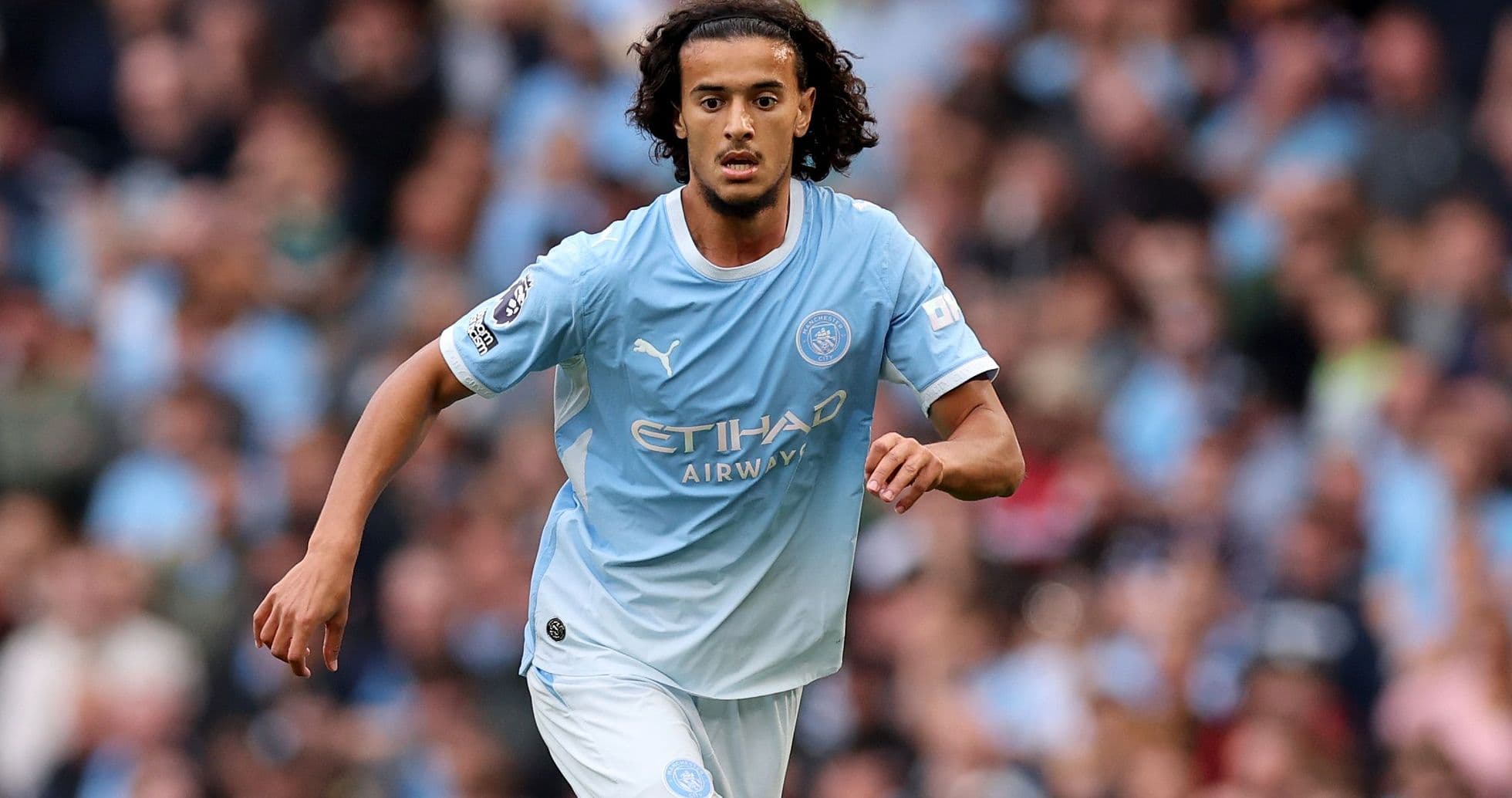 Player running during a Manchester City match Player running during a Manchester City match