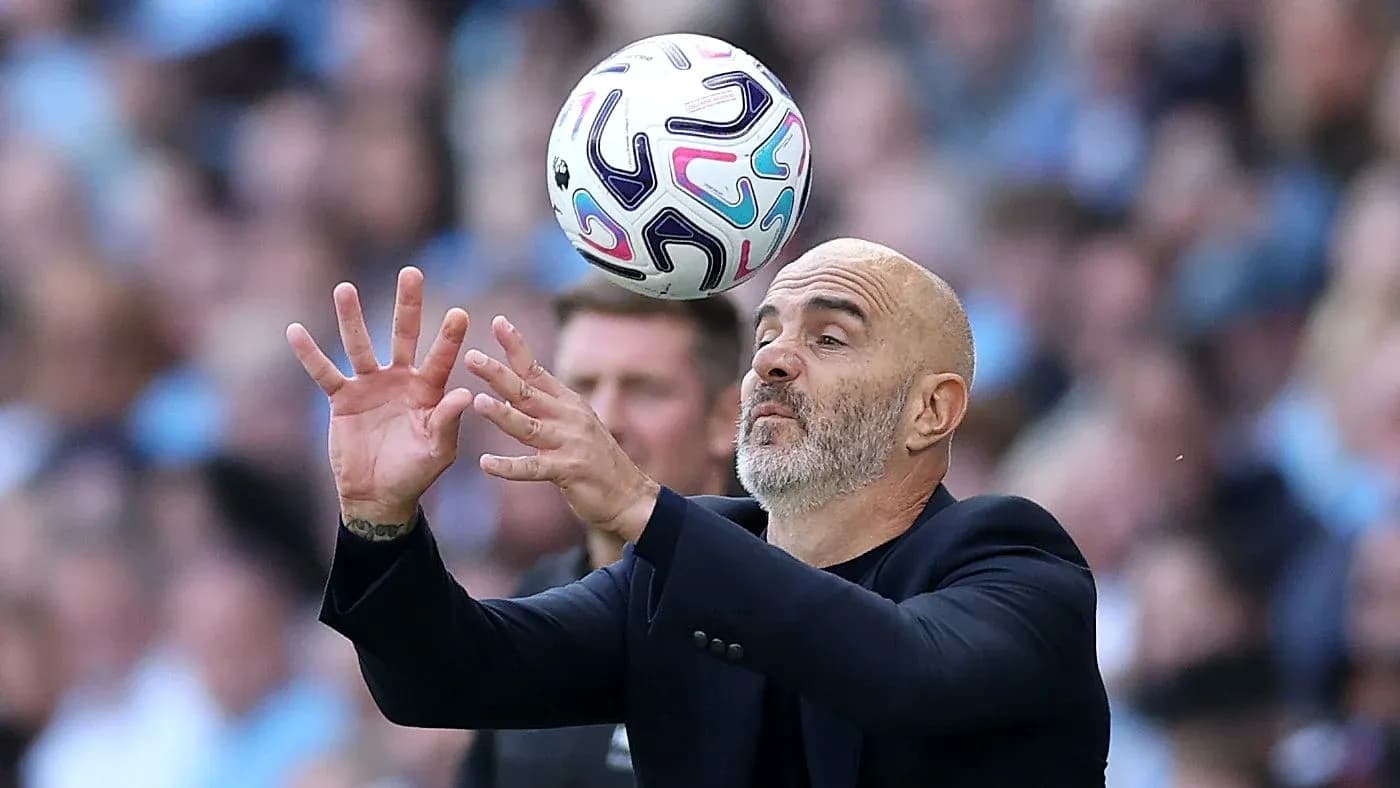 Coach attempting to catch a soccer ball during match Coach attempting to catch a soccer ball during match