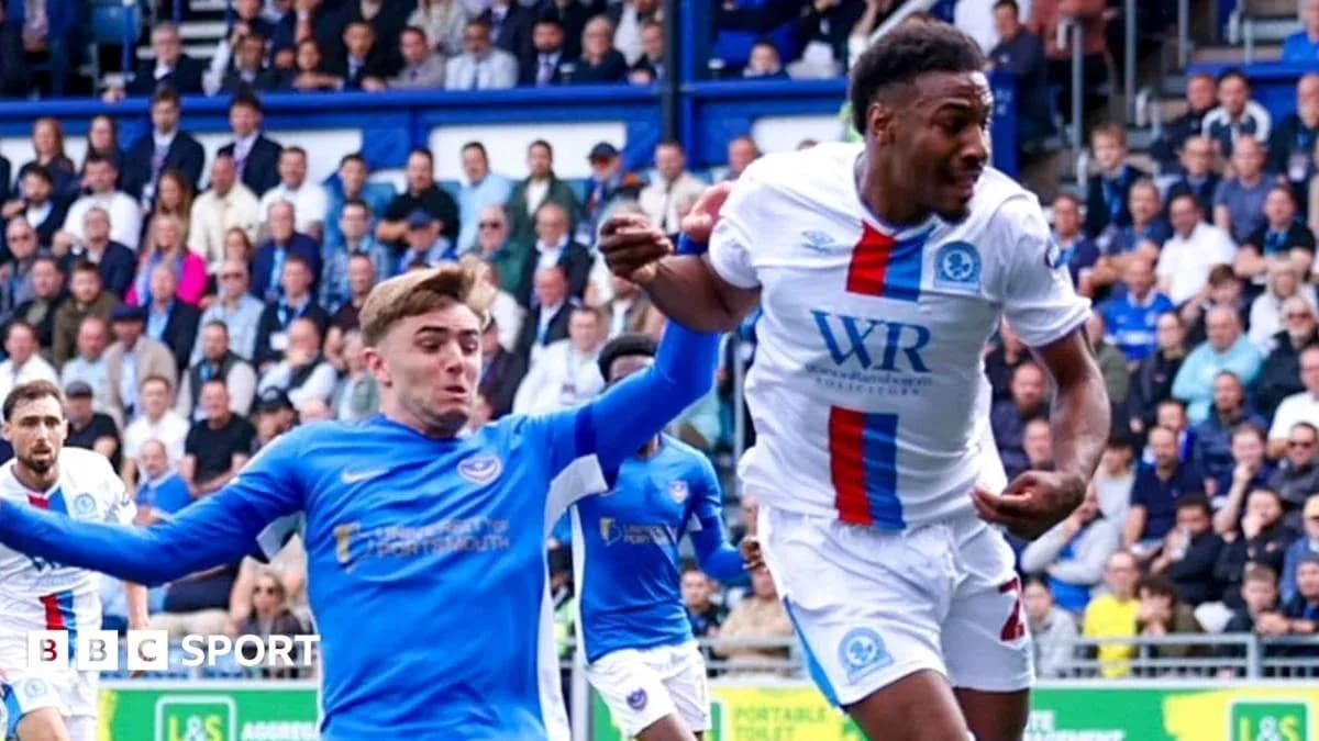 Player in blue attempting to tackle player in white Player in blue attempting to tackle player in white