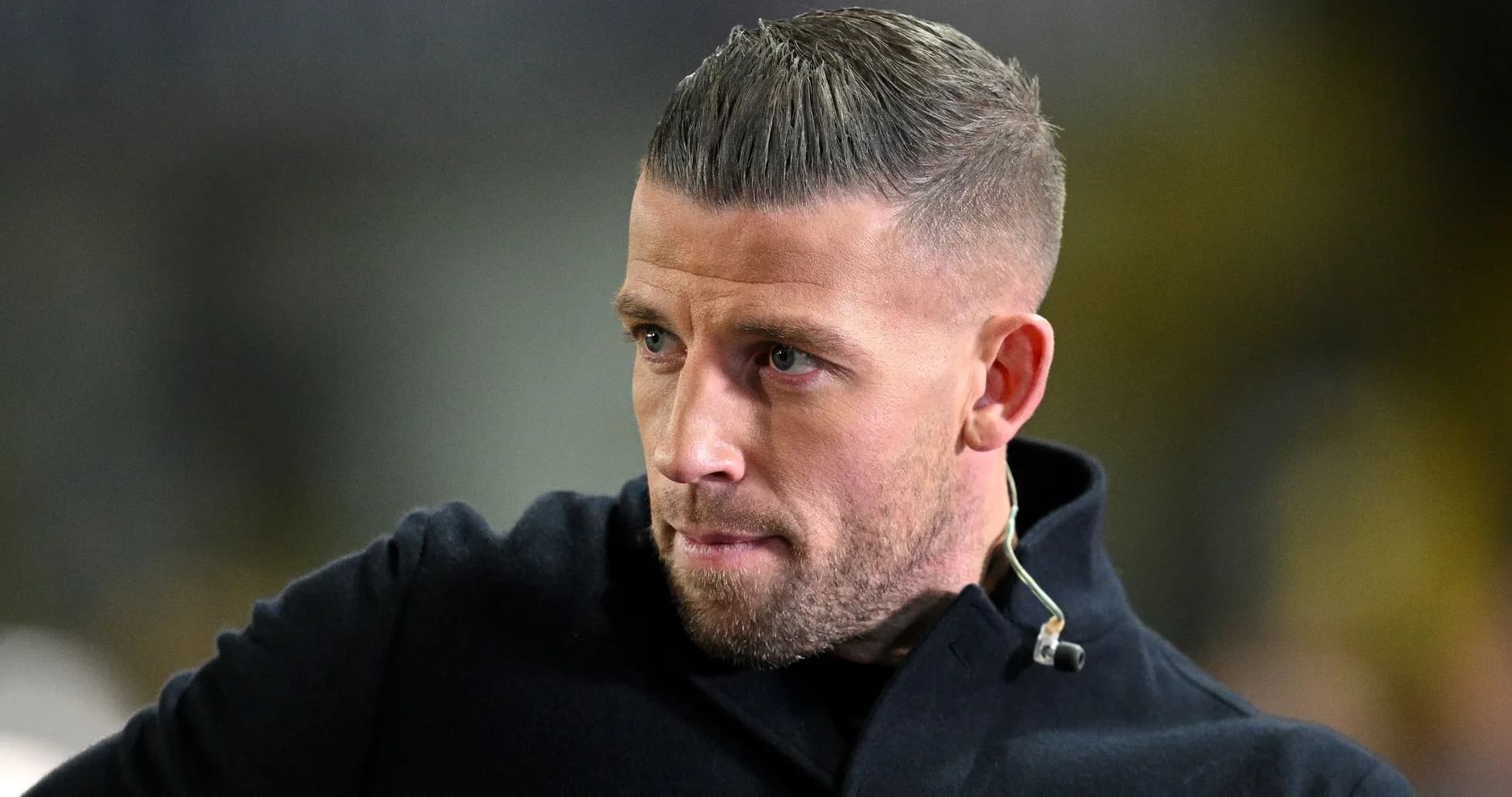 Man in a black coat looking intently Man in a black coat looking intently