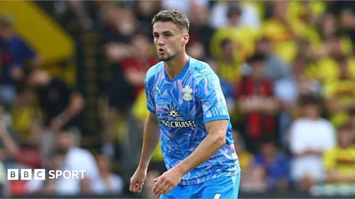 Player in blue kit during match at stadium Player in blue kit during match at stadium
