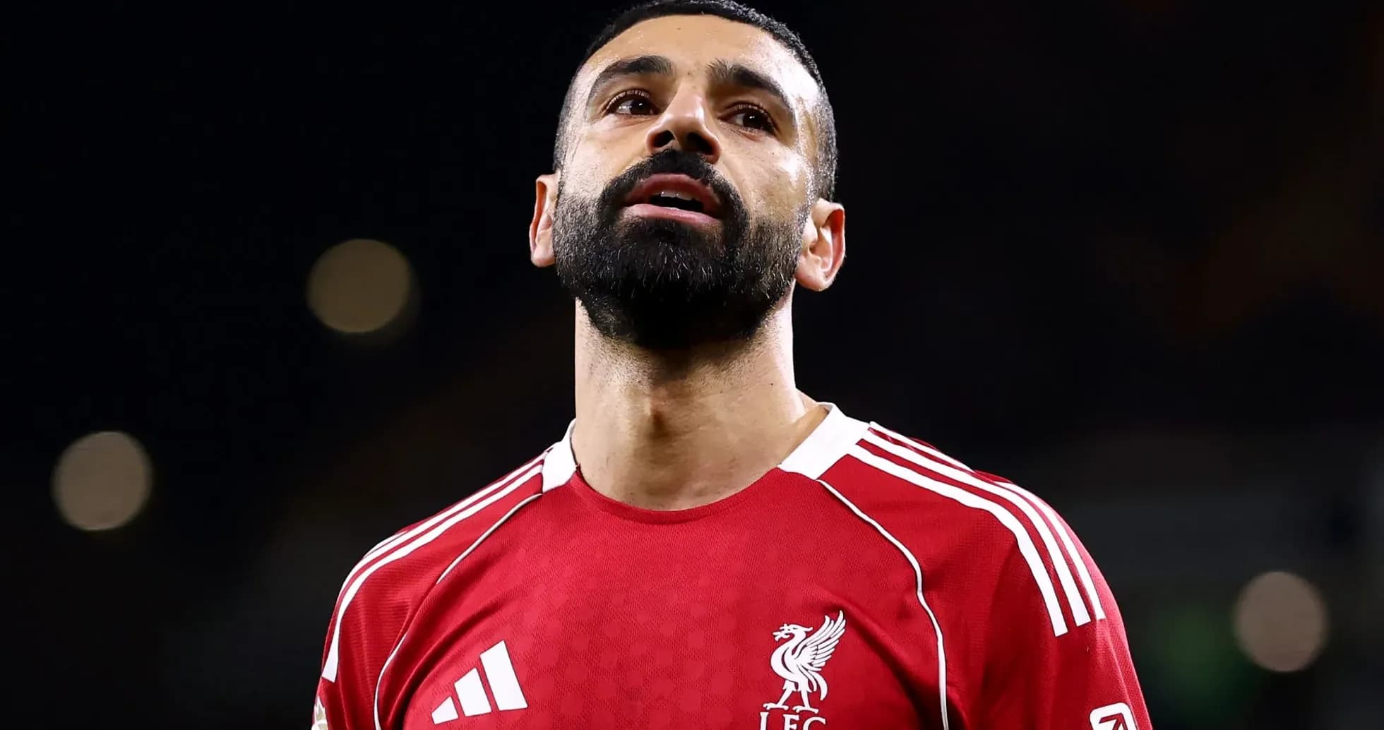Player in red Liverpool kit looking upwards Player in red Liverpool kit looking upwards