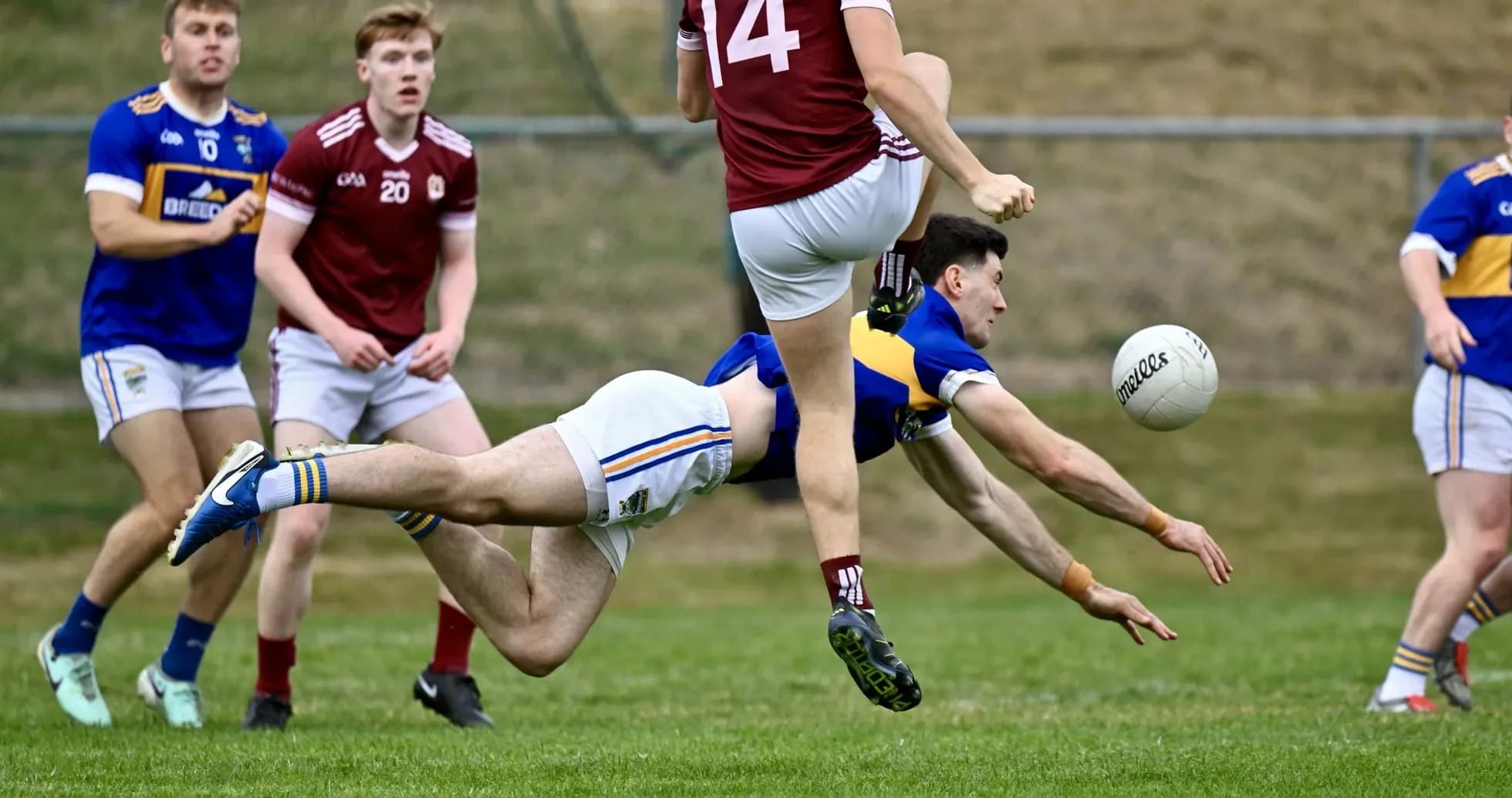 Player diving for the ball during a match Player diving for the ball during a match