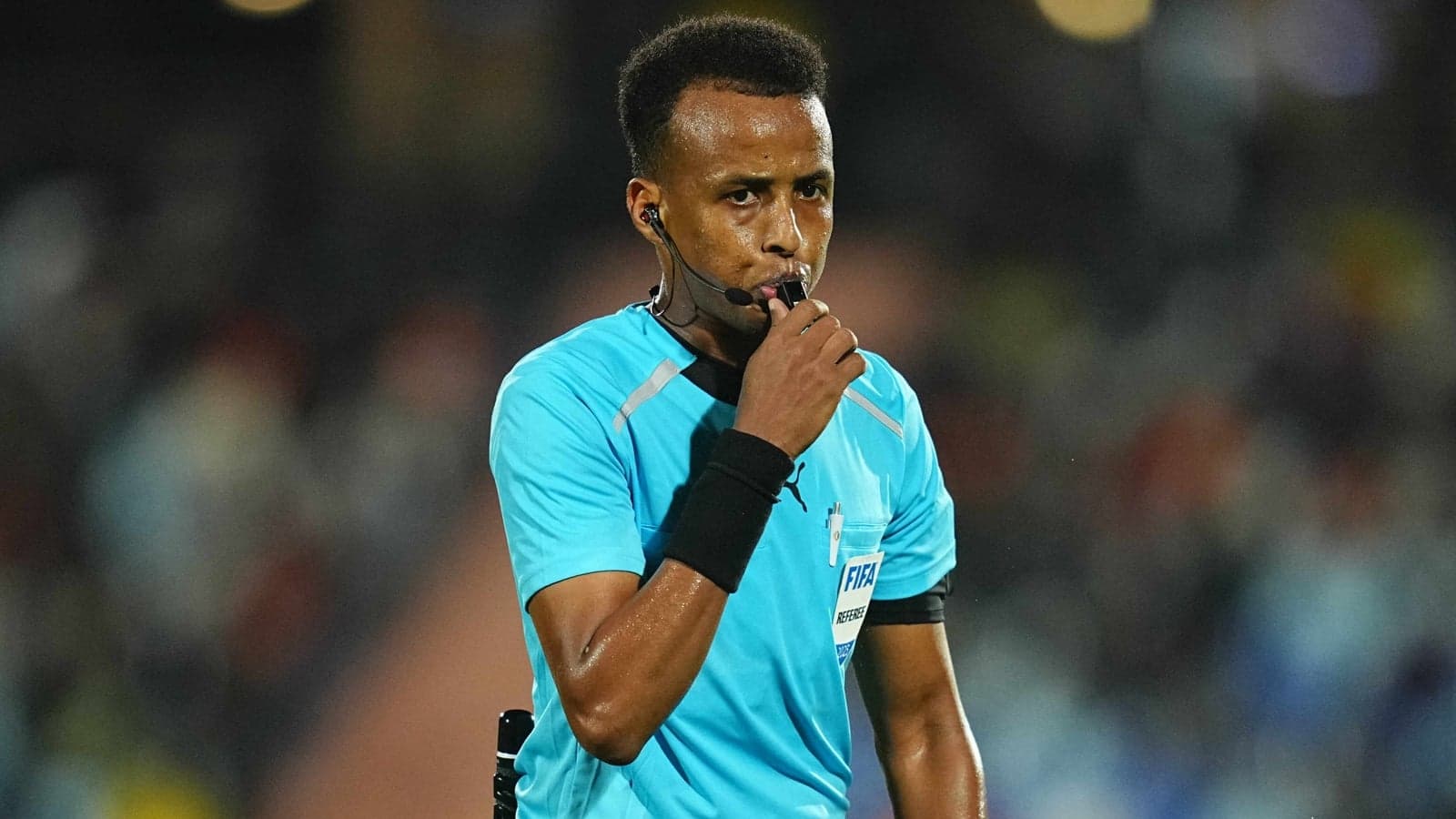 Referee blowing whistle during football match Referee blowing whistle during football match