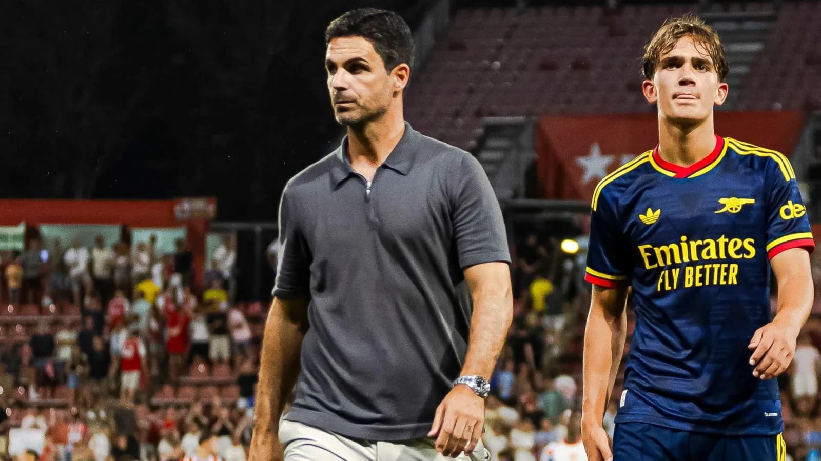 Coach and player walking off the field post-match Coach and player walking off the field post-match