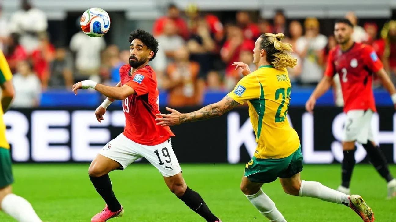 Player in red chasing the ball during match Player in red chasing the ball during match
