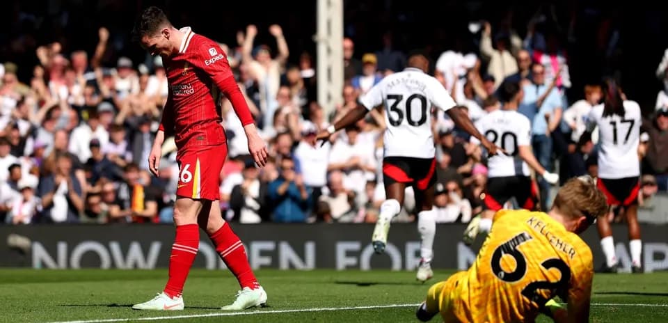 Liverpool player walks past Fulham celebrating goal Liverpool player walks past Fulham celebrating goal