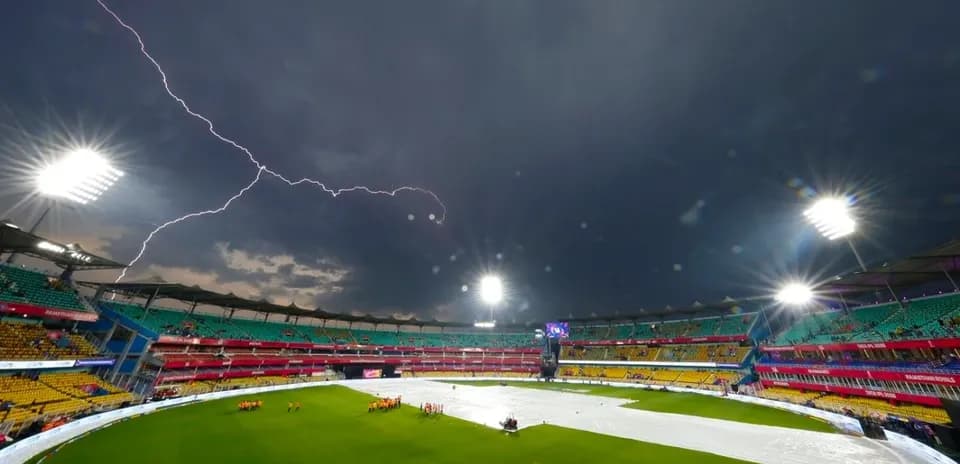 Cricket stadium under stormy sky with lightning Cricket stadium under stormy sky with lightning