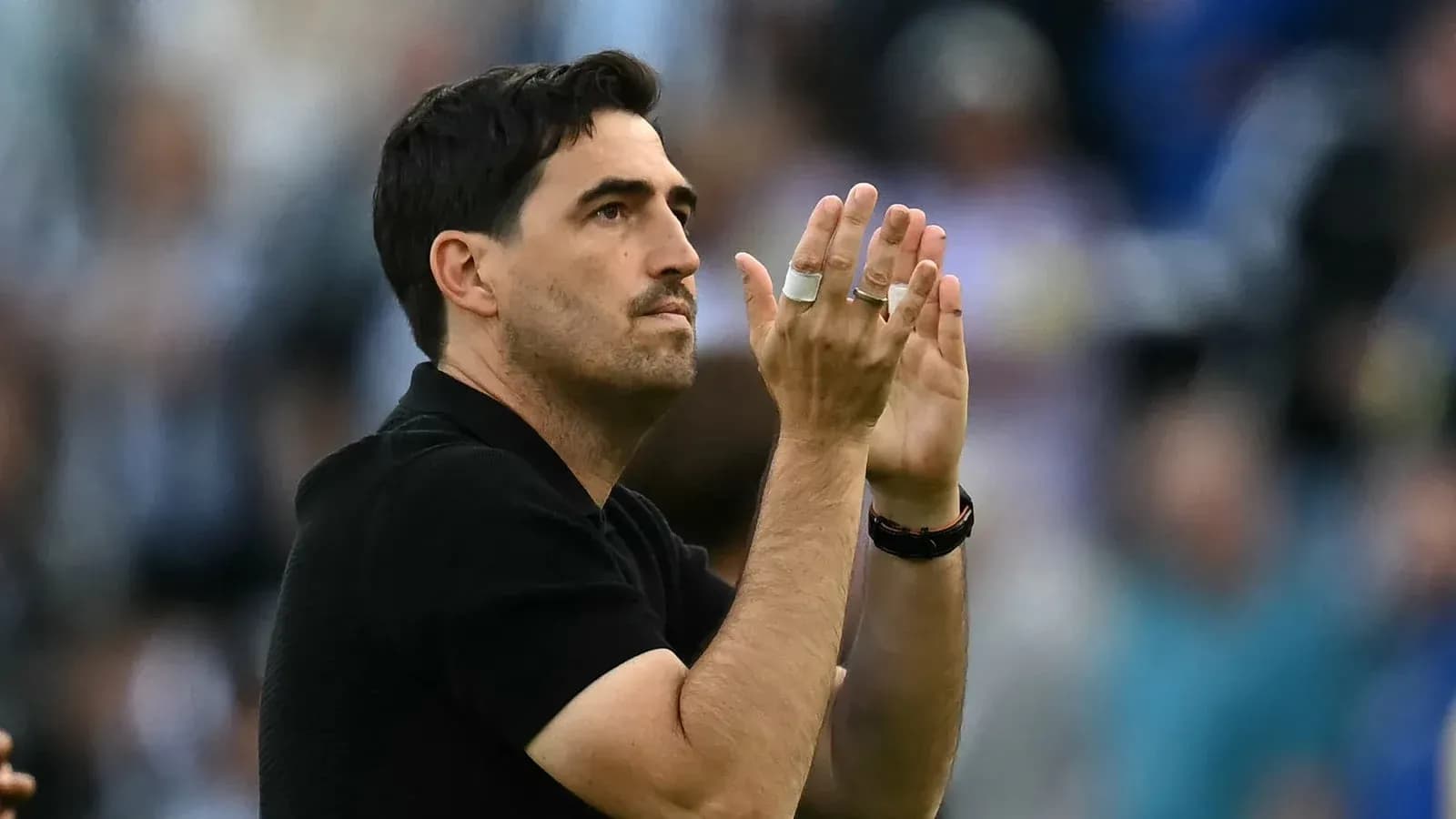 Coach applauding during match at stadium Coach applauding during match at stadium