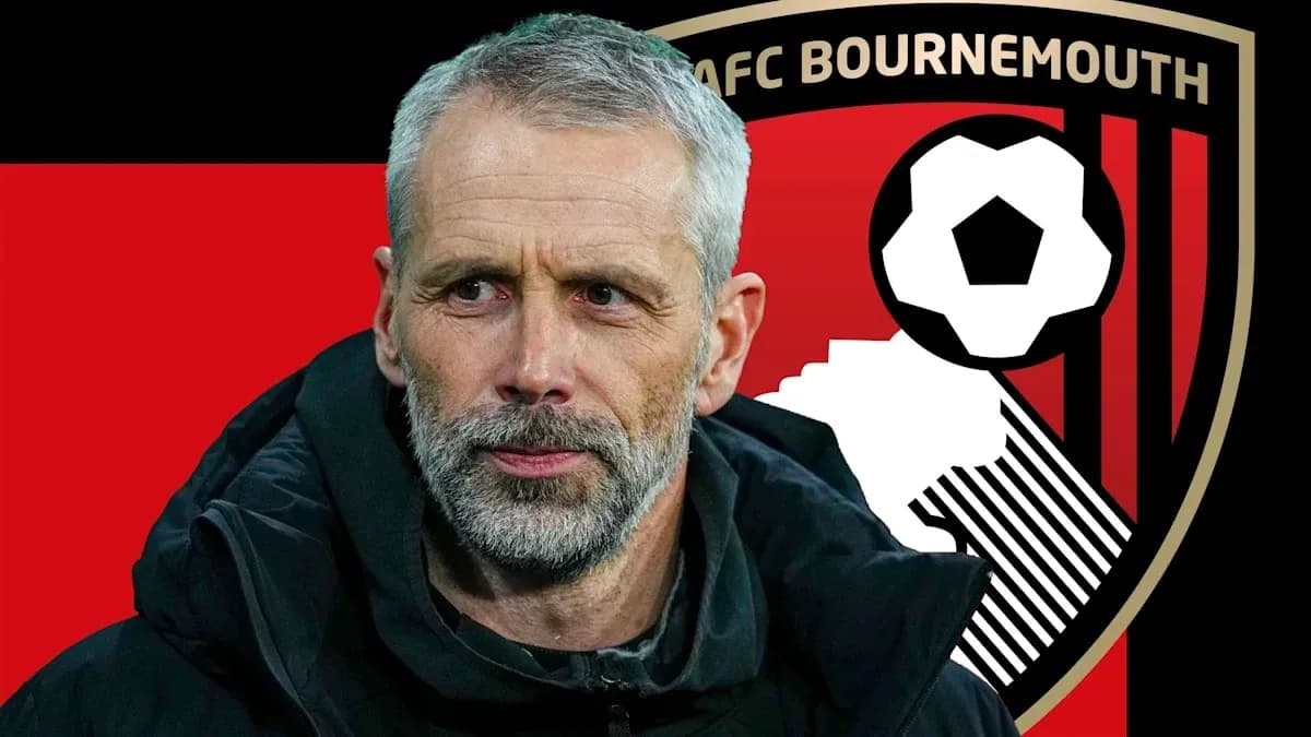 AFC Bournemouth manager in front of club logo AFC Bournemouth manager in front of club logo