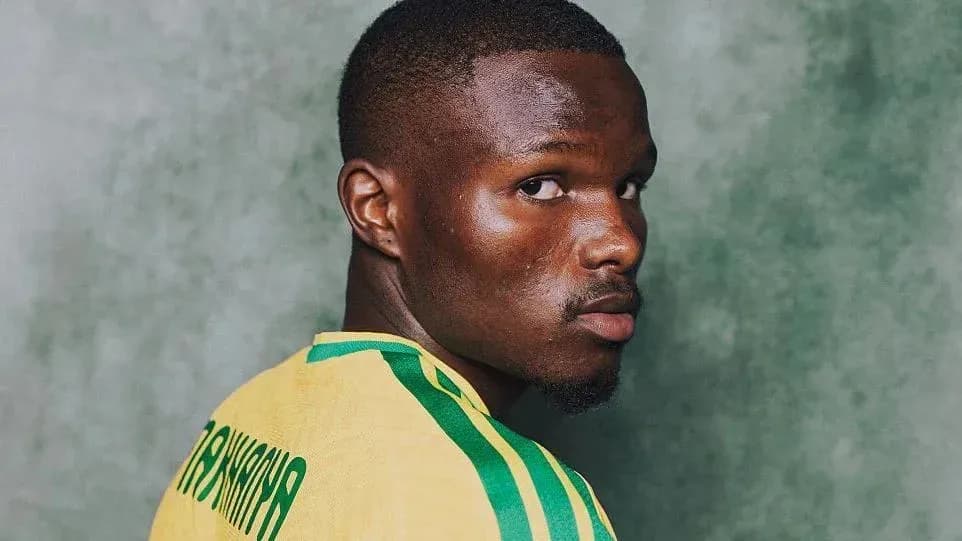 Player wearing a yellow jersey, looking over shoulder Player wearing a yellow jersey, looking over shoulder