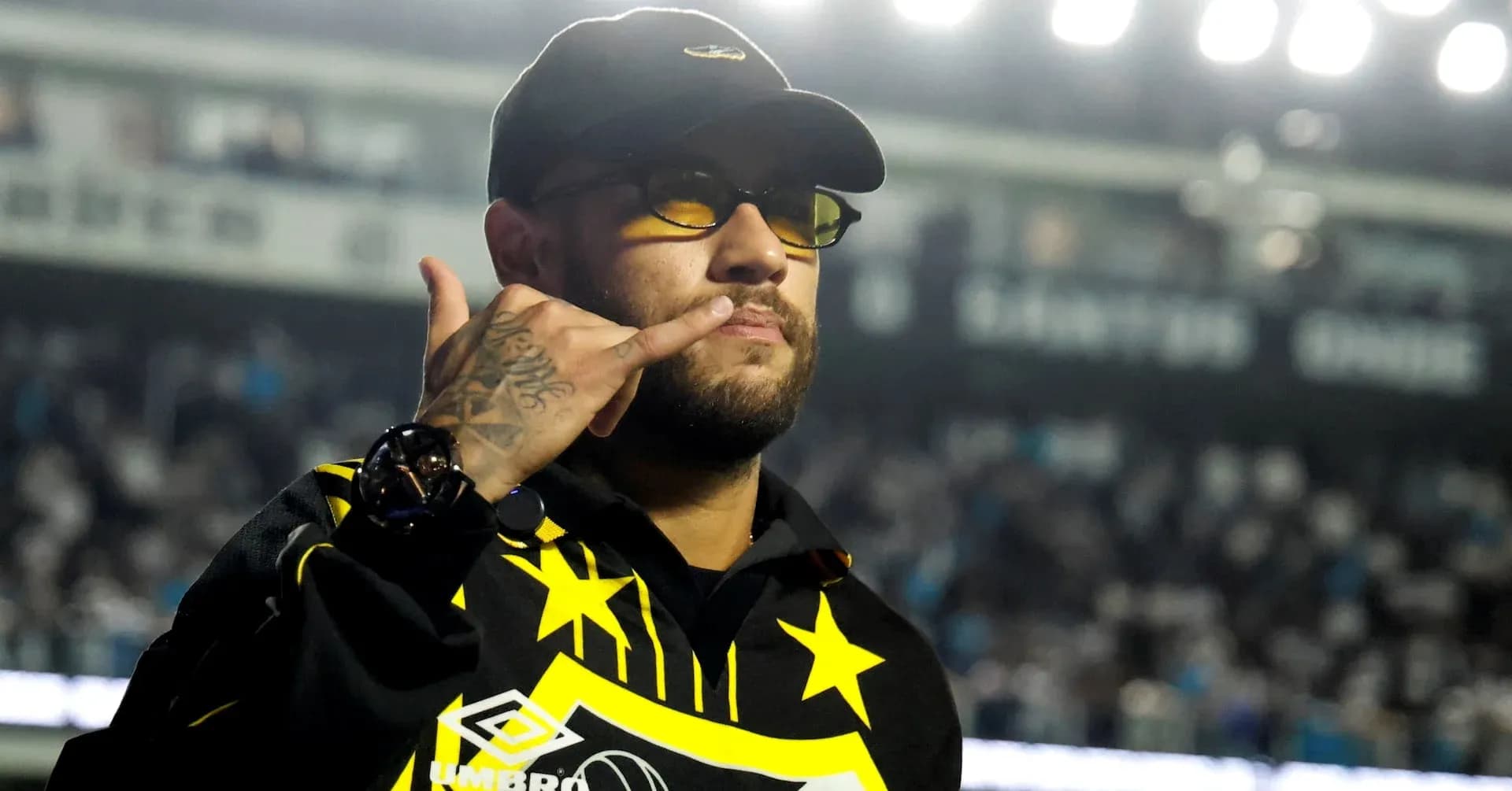 Person making a gesture in a stadium setting Person making a gesture in a stadium setting