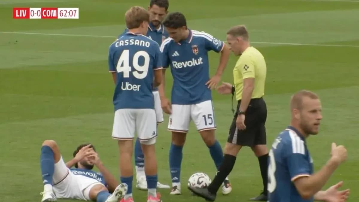 Players gathered around an injured teammate on field Players gathered around an injured teammate on field