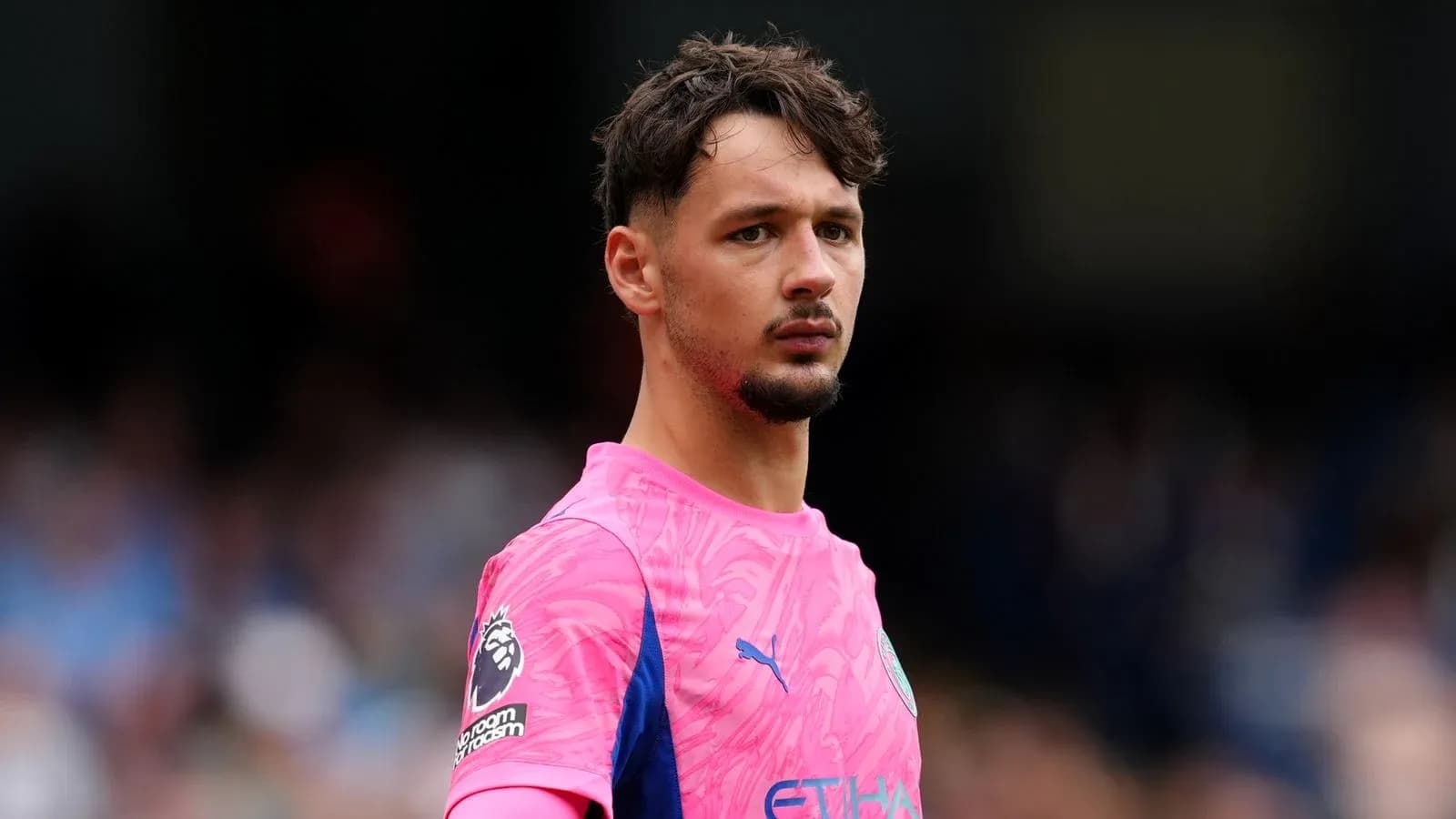 Goalkeeper in pink kit during match Goalkeeper in pink kit during match