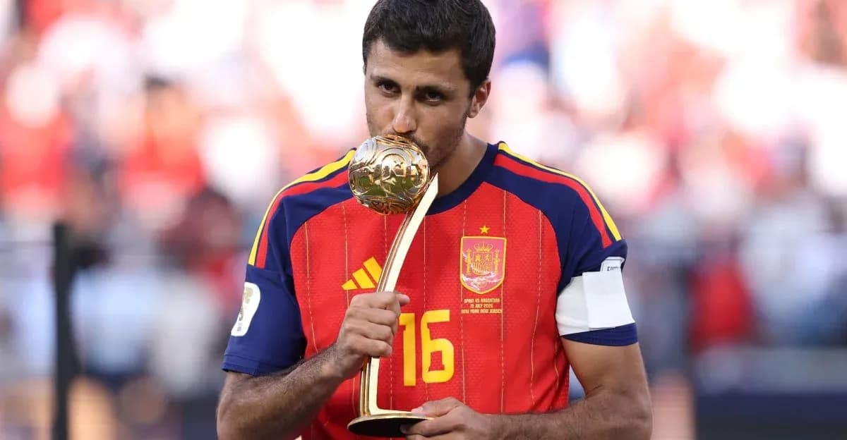 Player in Spain jersey kissing trophy on field Player in Spain jersey kissing trophy on field