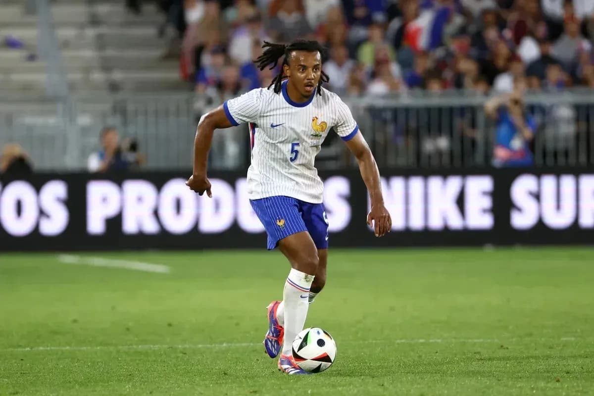 Player in France kit dribbling soccer ball on field Player in France kit dribbling soccer ball on field