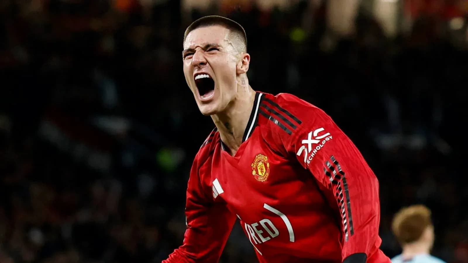 Player celebrating enthusiastically in Manchester United jersey Player celebrating enthusiastically in Manchester United jersey