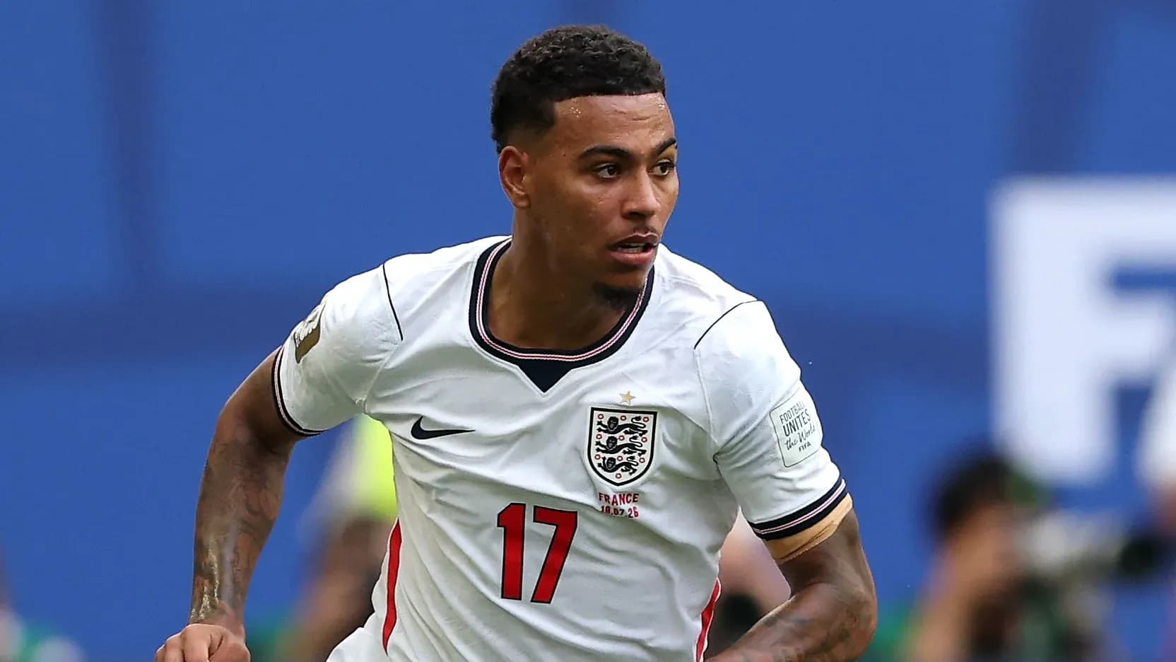 Player running during an international football match Player running during an international football match