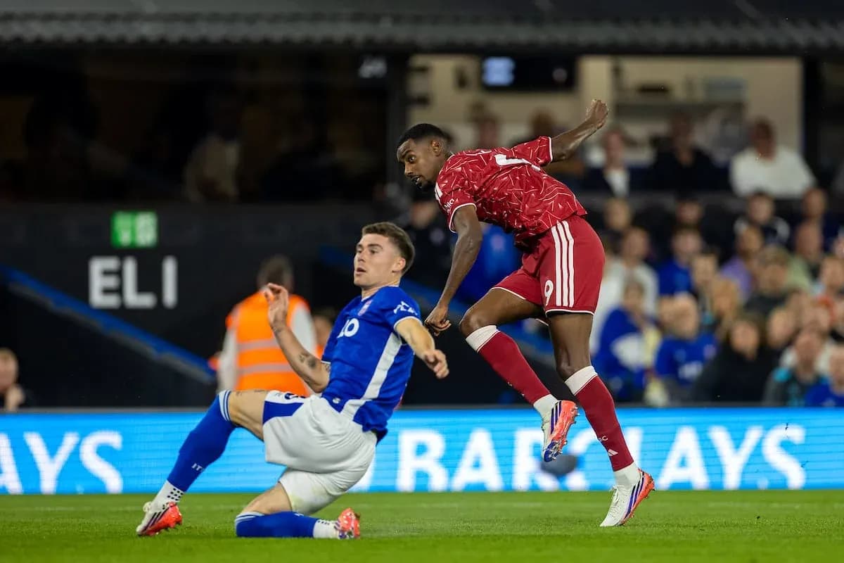 Ipswich player tackling Liverpool forward during match Ipswich player tackling Liverpool forward during match
