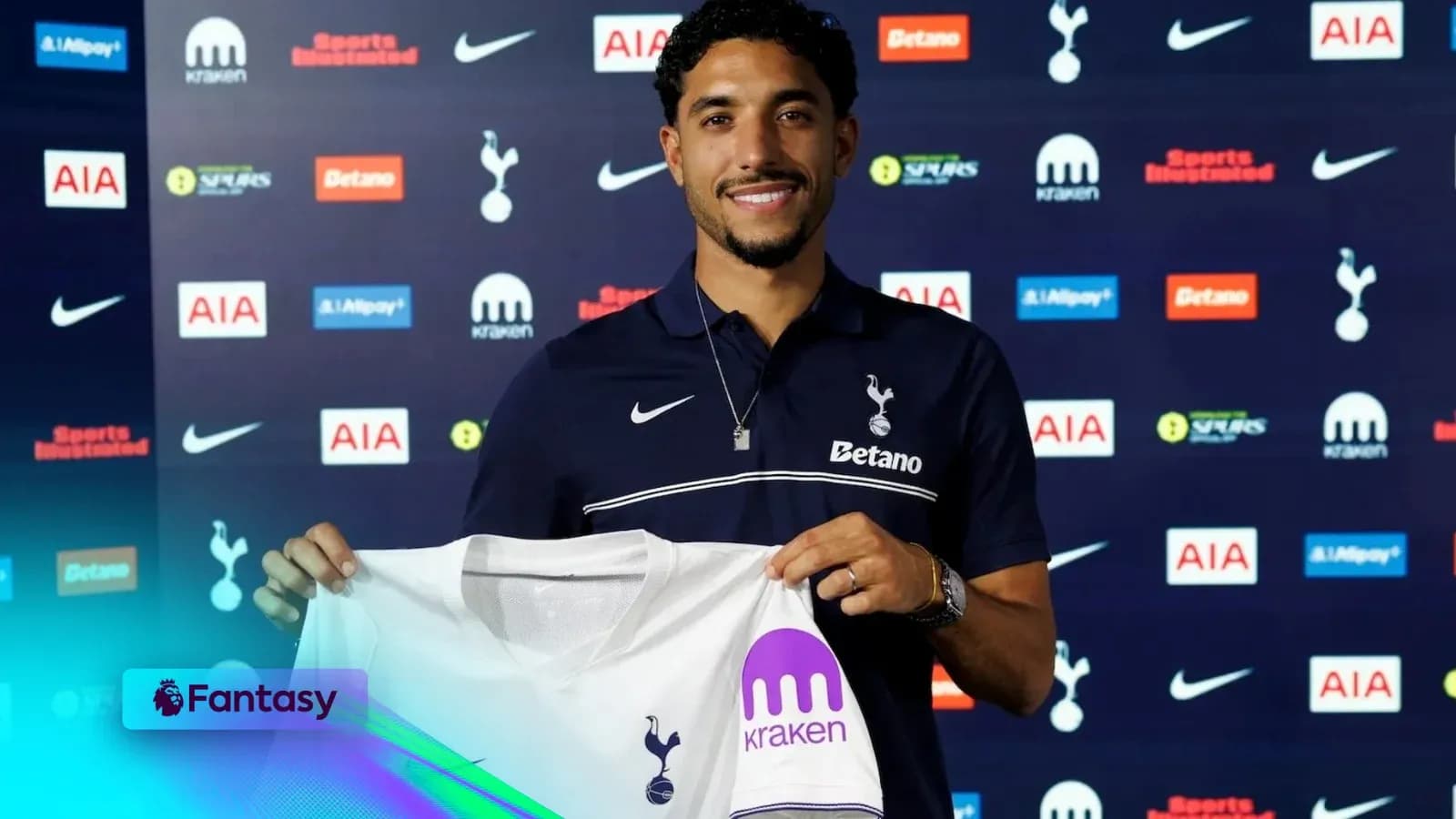 Player holding Tottenham Hotspur jersey at signing event Player holding Tottenham Hotspur jersey at signing event