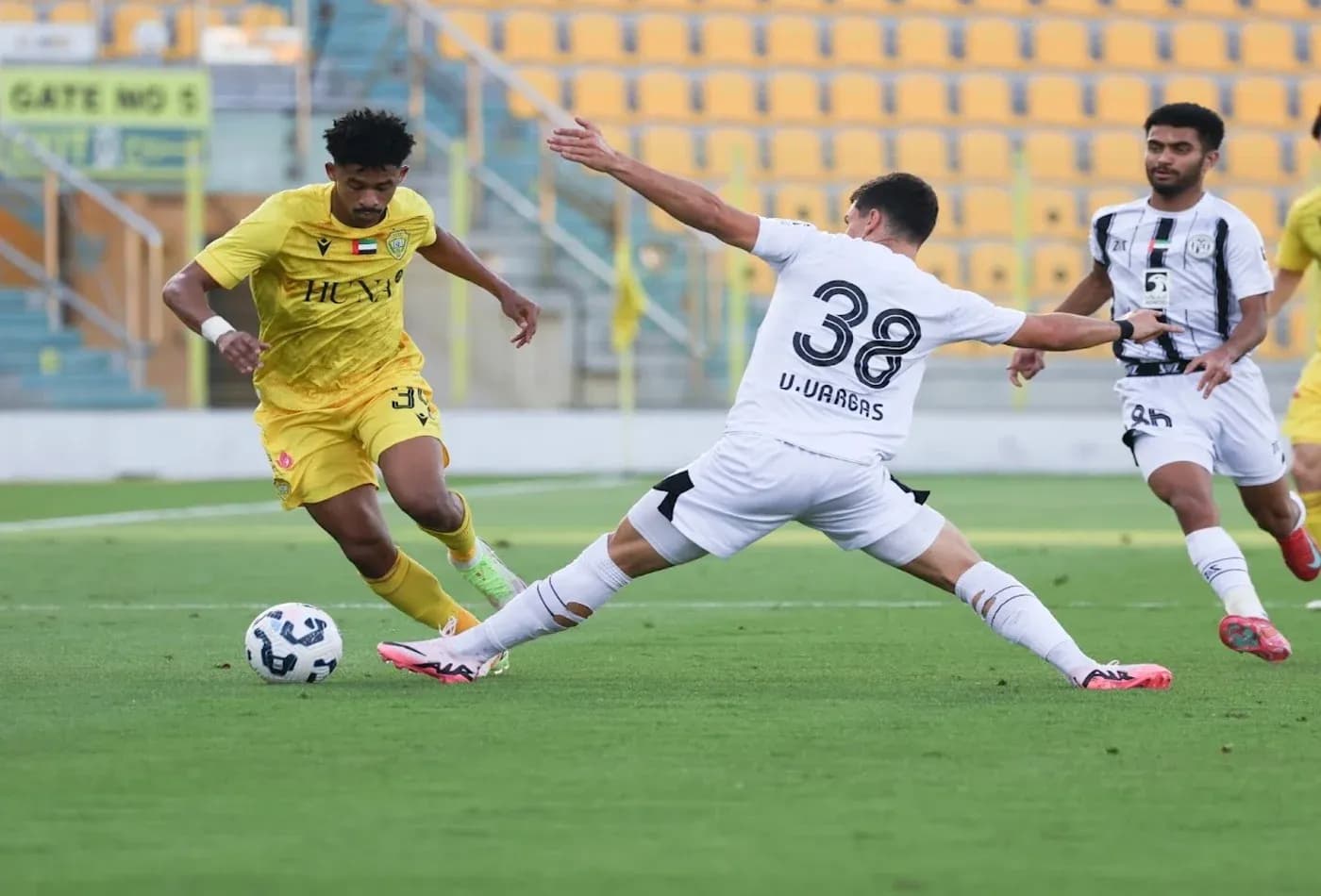 Al Wasl U23 player dribbling past Al Jazira U23 opponent Al Wasl U23 player dribbling past Al Jazira U23 opponent