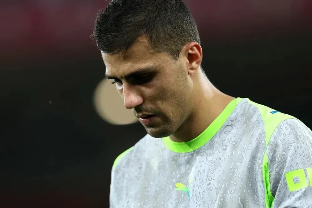 Player looking down in training gear with raindrops Player looking down in training gear with raindrops