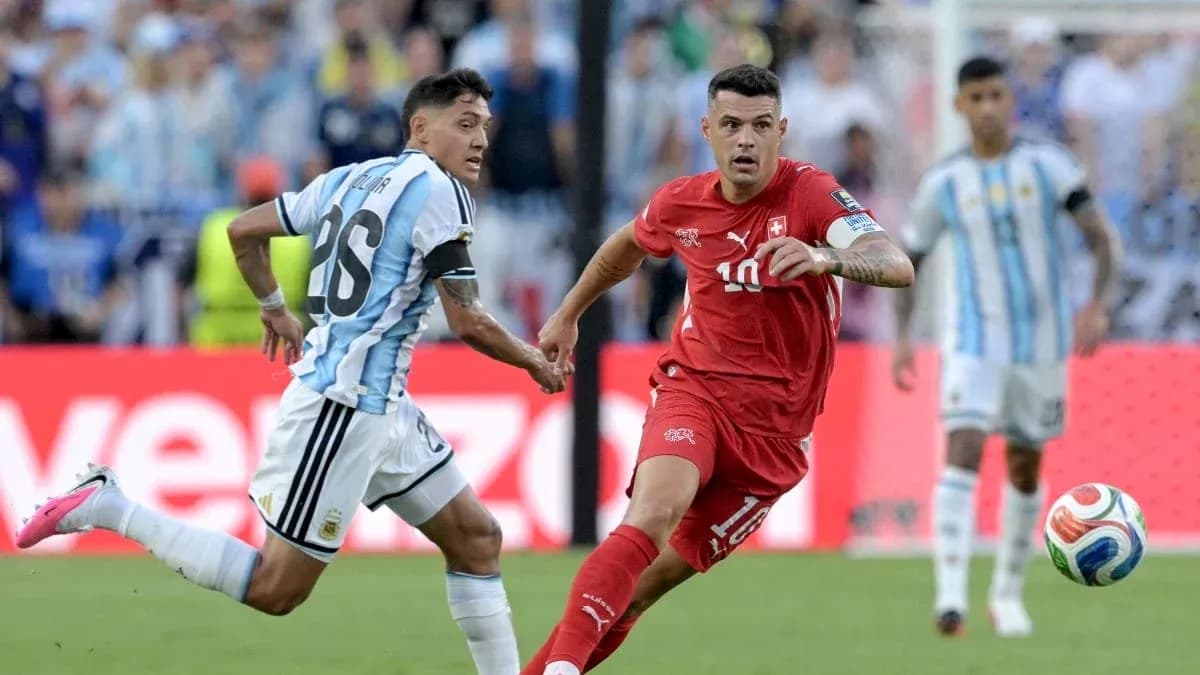 Argentinian player chasing Swiss player with ball Argentinian player chasing Swiss player with ball