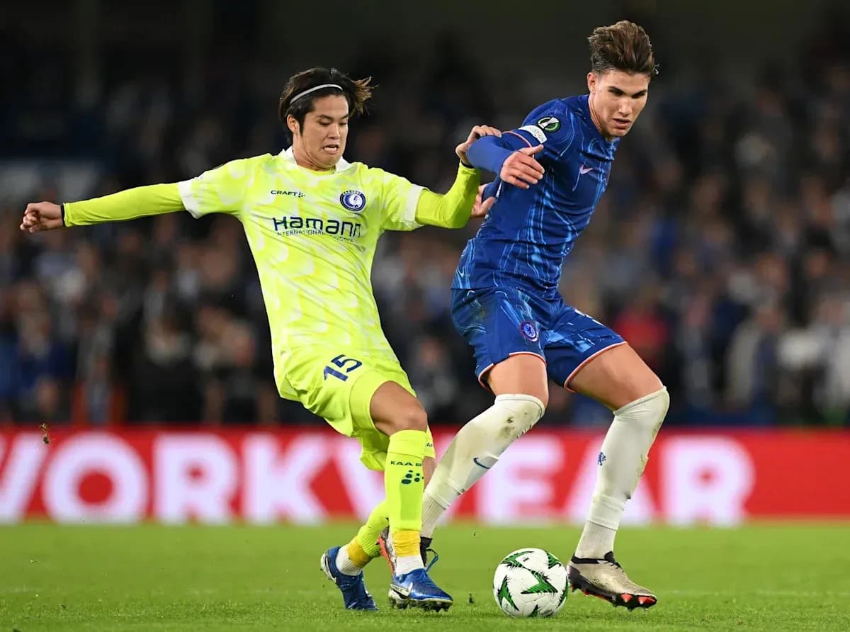 Two players contesting the ball during a match Two players contesting the ball during a match