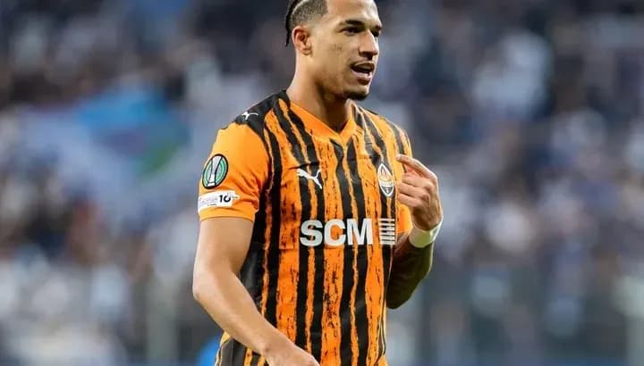 Player in orange and black jersey during match Player in orange and black jersey during match