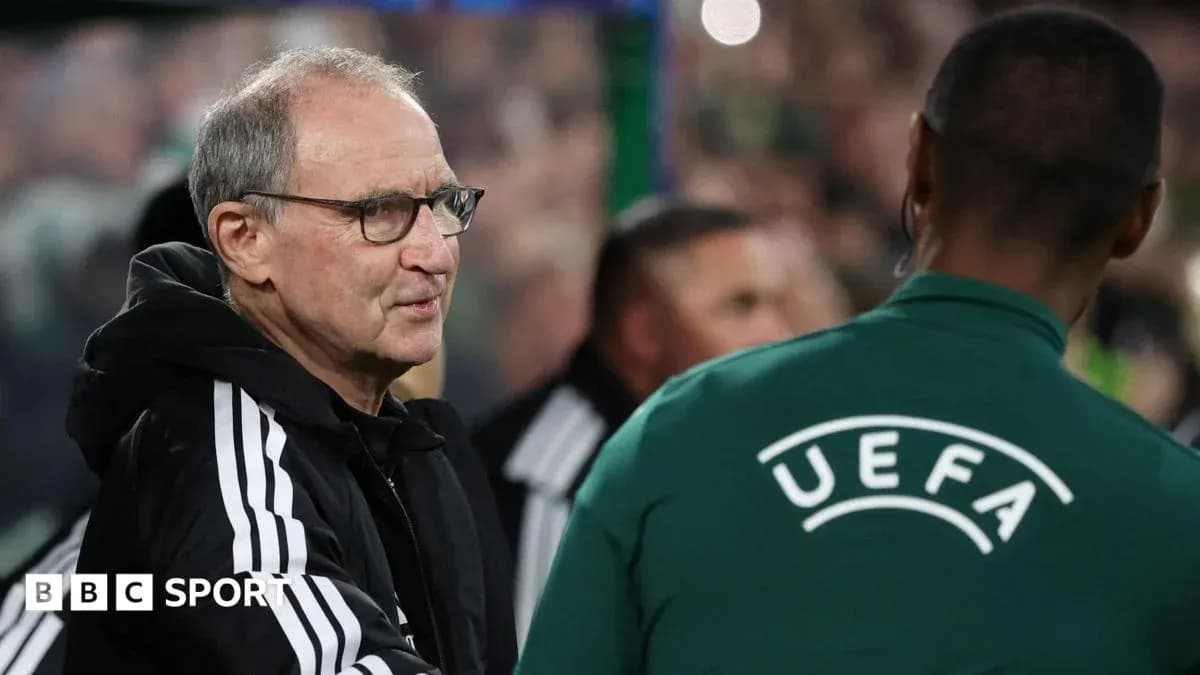 Coach interacting with UEFA official on sidelines Coach interacting with UEFA official on sidelines
