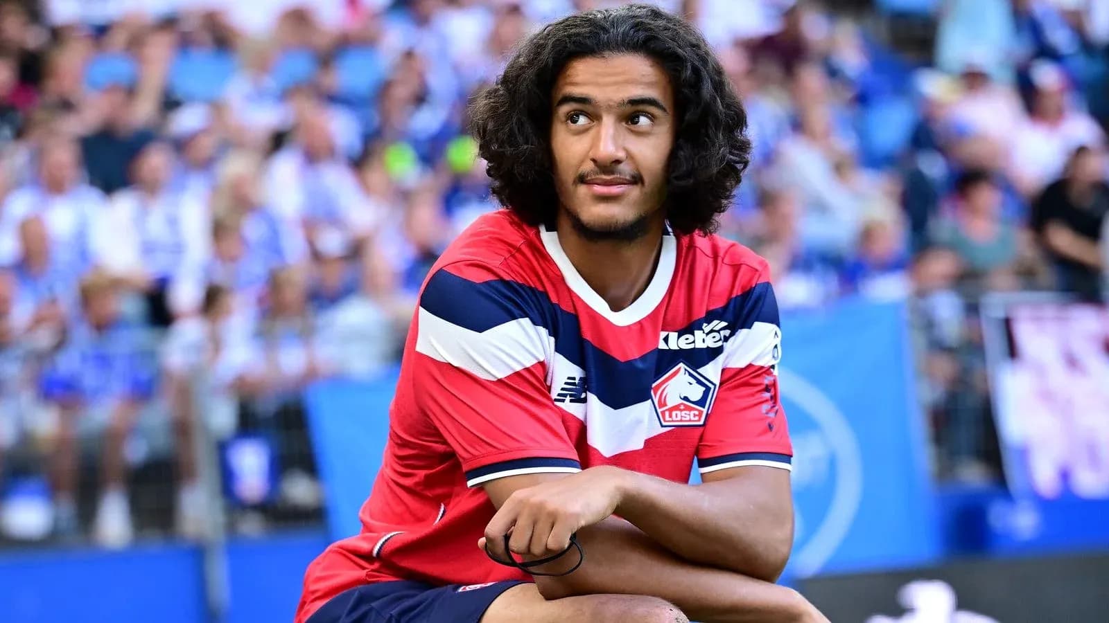 Player sitting on the pitch during a match Player sitting on the pitch during a match