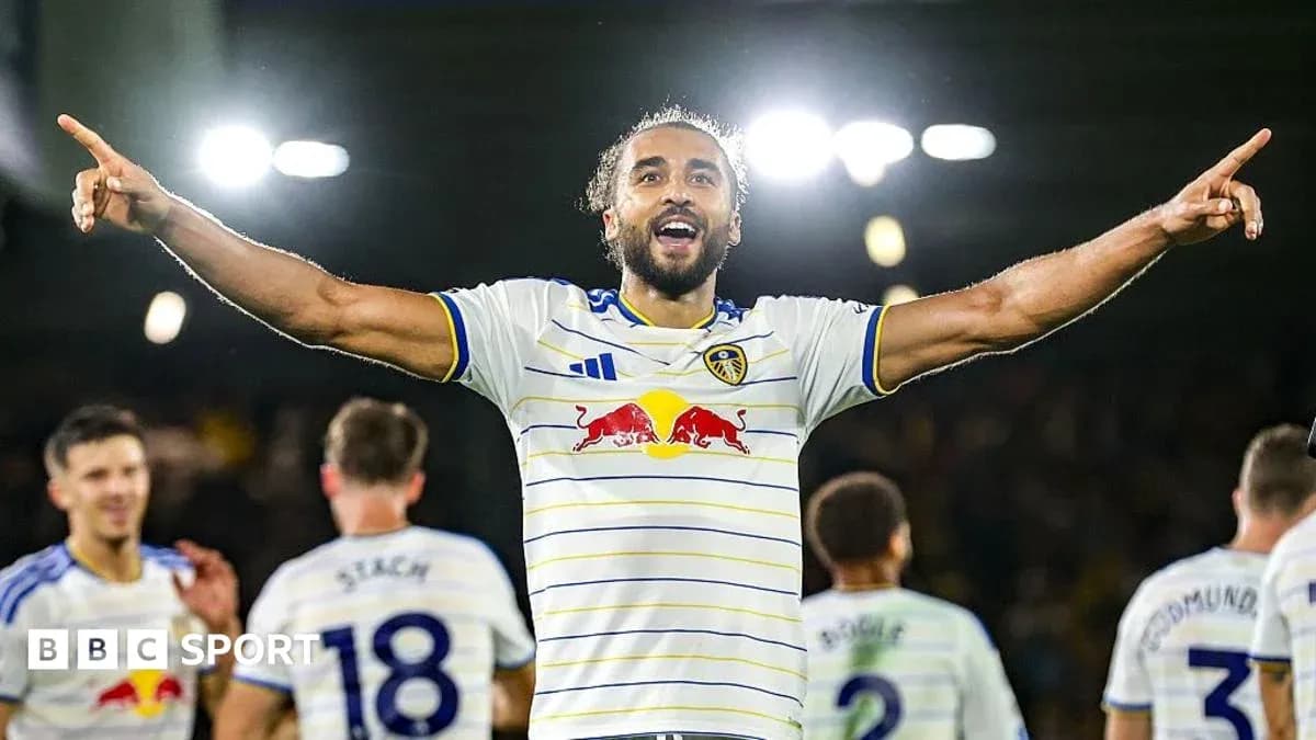 Player celebrating a goal with teammates in stadium Player celebrating a goal with teammates in stadium