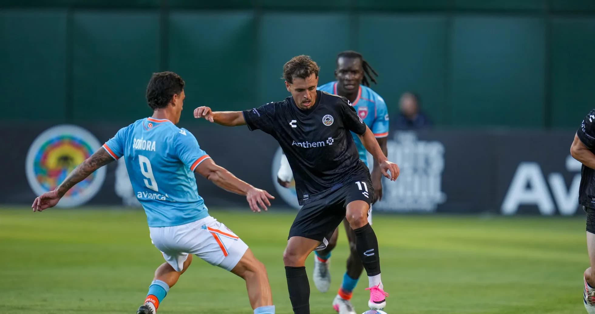 Player dribbling past opponent during match Player dribbling past opponent during match