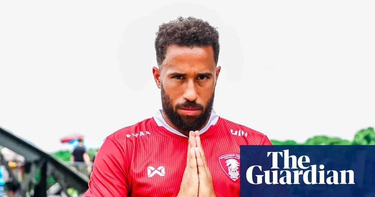 Player in red jersey with hands together in prayer Player in red jersey with hands together in prayer