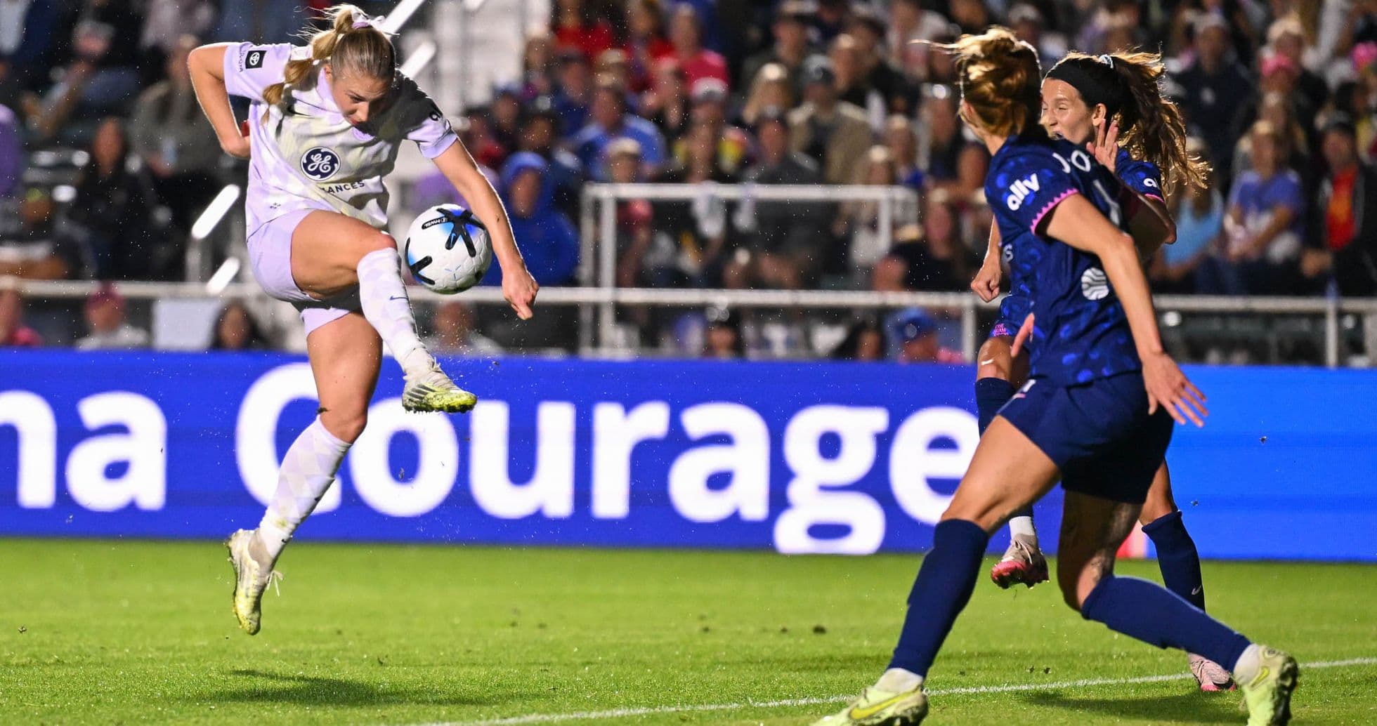 Player striking the ball during NWSL match Player striking the ball during NWSL match